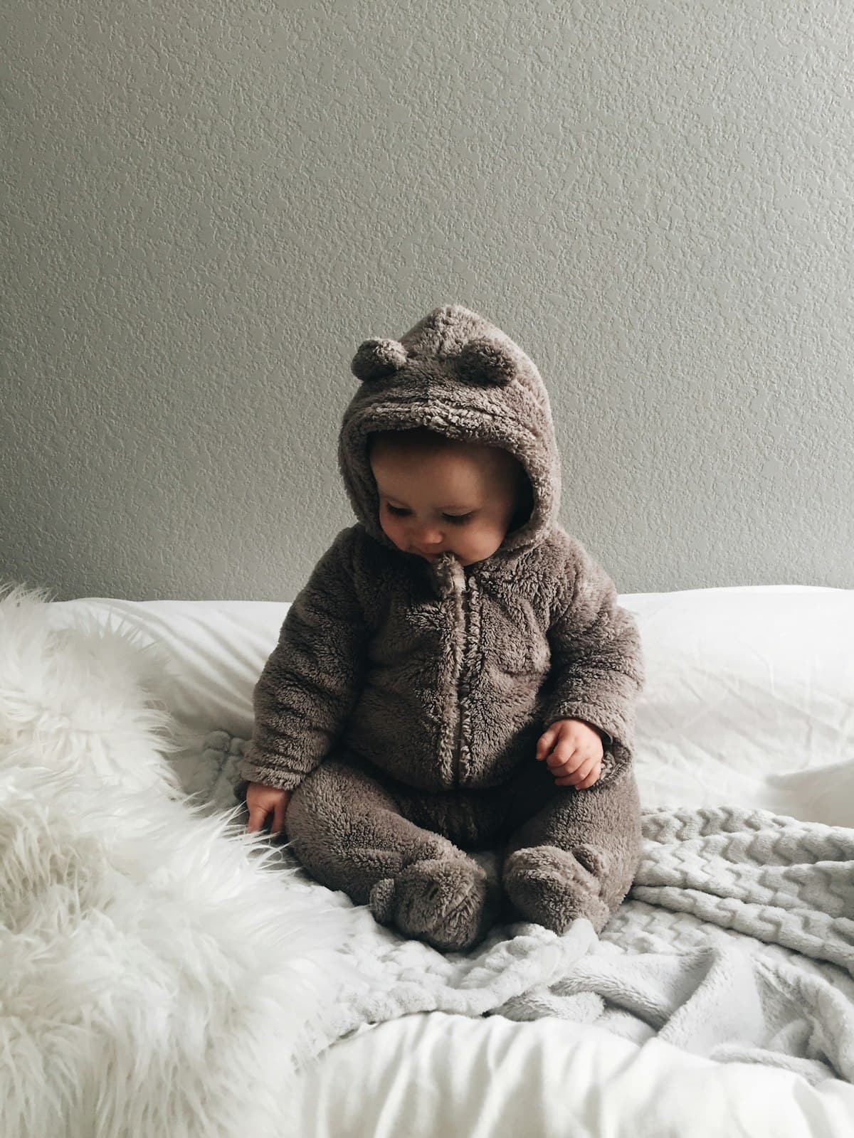 Folded baby clothes in soft light